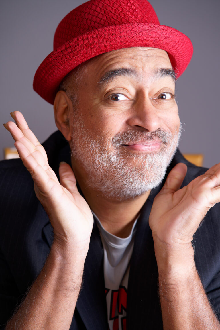 Vance Gilbert with his hands around his face.